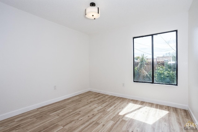 spare room featuring light wood-type flooring