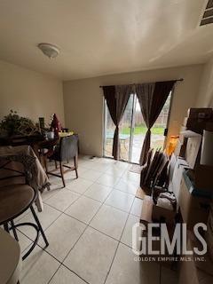 living room with light tile patterned floors and visible vents