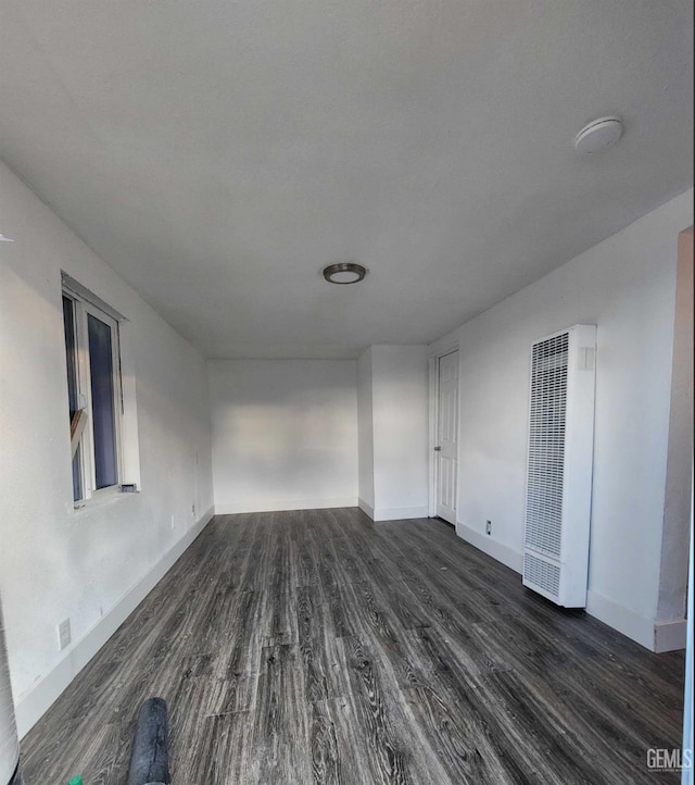 spare room with dark wood-type flooring