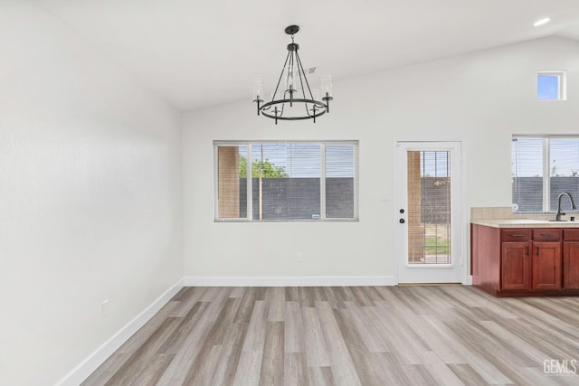 9610 Tahiti Ave, Bakersfield, CA 93311 - unfurnished dining area featuring light wood-style floors, a chandelier, and high vaulted ceiling