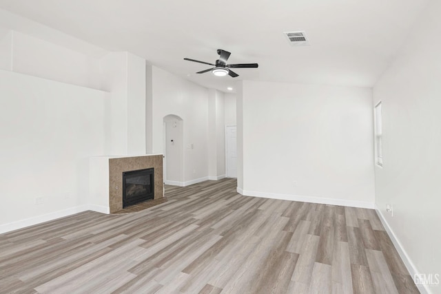 9610 Tahiti Ave, Bakersfield, CA 93311 - unfurnished living room with ceiling fan, wood finished floors, arched walkways, a fireplace, and recessed lighting