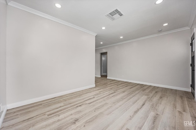 empty room featuring crown molding, light wood finished floors, recessed lighting, baseboards, and visible vents