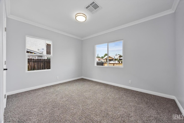 carpeted empty room with visible vents, baseboards, and crown molding