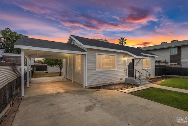 bungalow featuring fence and concrete driveway