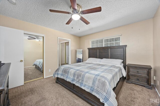 carpeted bedroom with baseboards, a textured ceiling, and ceiling fan