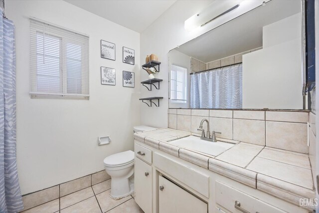 bathroom featuring vanity, a shower with curtain, decorative backsplash, tile patterned floors, and toilet