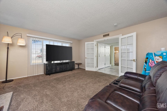 living area featuring french doors, a textured ceiling, visible vents, and carpet flooring