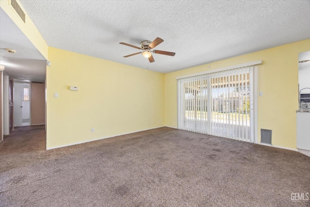 spare room with visible vents, carpet flooring, a textured ceiling, and a ceiling fan