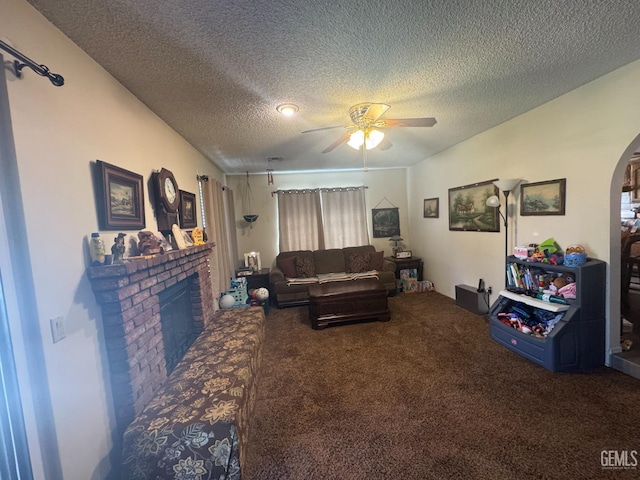 4105 Thatch Ave, Bakersfield, CA 93313 - carpeted living room with a ceiling fan, arched walkways, a textured ceiling, and a fireplace