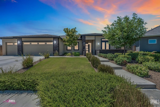 802 Barre Ct, Bakersfield, CA 93314 - prairie-style house with a garage, a yard, driveway, and stone siding