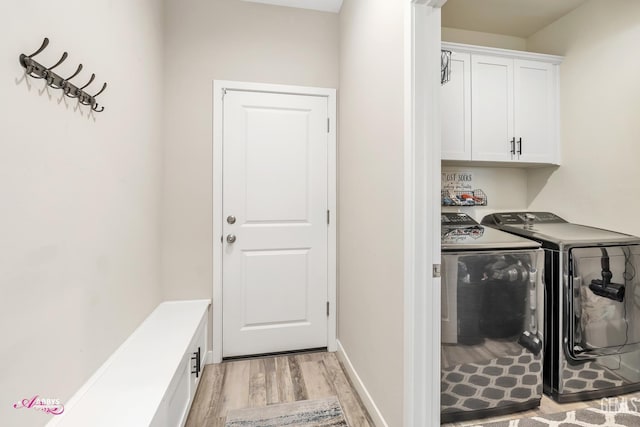 802 Barre Ct, Bakersfield, CA 93314 - washroom with washing machine and clothes dryer, cabinet space, and light wood-type flooring