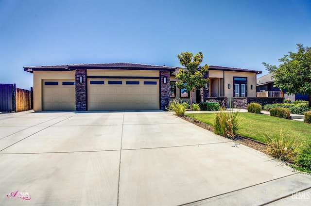 802 Barre Ct, Bakersfield, CA 93314 - prairie-style house with an attached garage, driveway, and stone siding