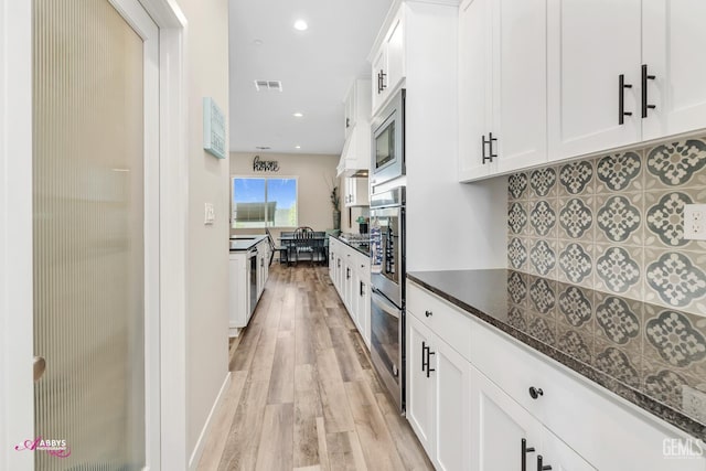 802 Barre Ct, Bakersfield, CA 93314 - kitchen featuring light wood-type flooring, white cabinetry, recessed lighting, dark stone countertops, and appliances with stainless steel finishes