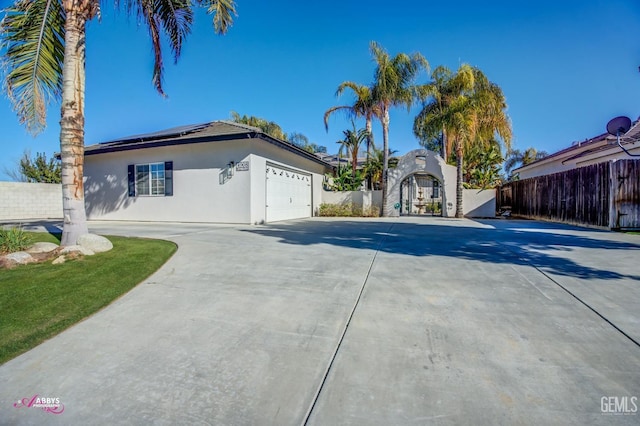 view of front of property featuring solar panels and a garage