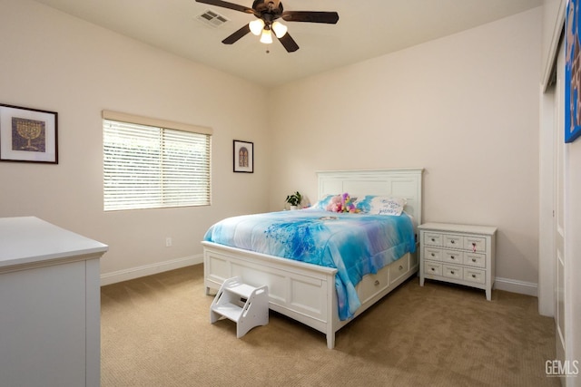 bedroom with baseboards, visible vents, ceiling fan, and light colored carpet