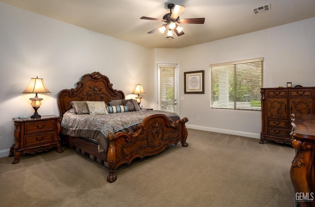 carpeted bedroom featuring visible vents, a ceiling fan, and baseboards