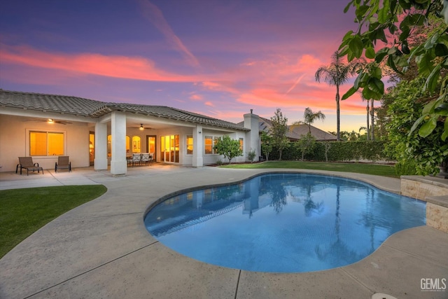 pool with a yard, a ceiling fan, and a patio