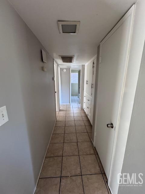 corridor featuring light tile patterned floors