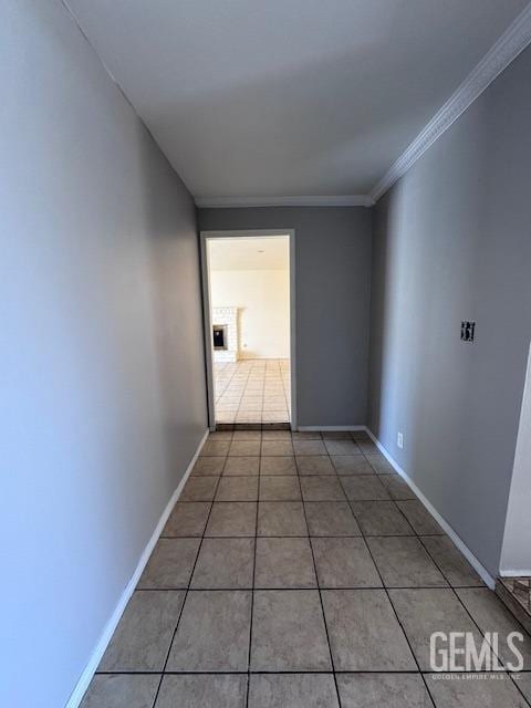 unfurnished room featuring crown molding and tile patterned floors