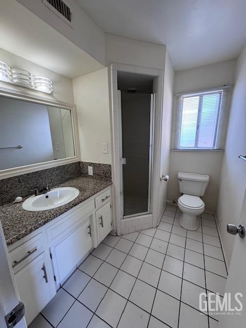 bathroom with vanity, an enclosed shower, tile patterned floors, and toilet