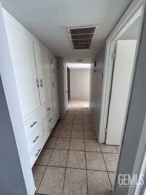 hallway featuring light tile patterned floors