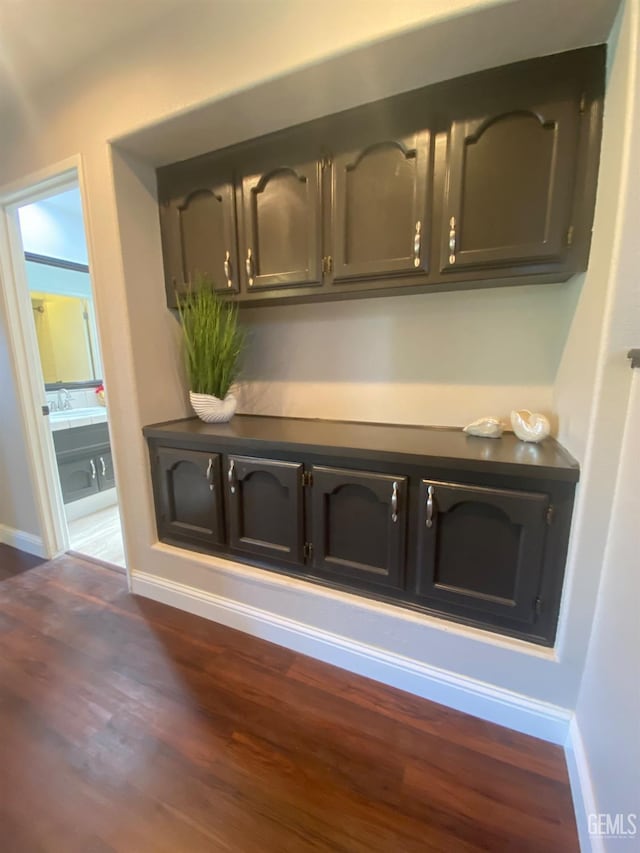 bar with dark hardwood / wood-style floors