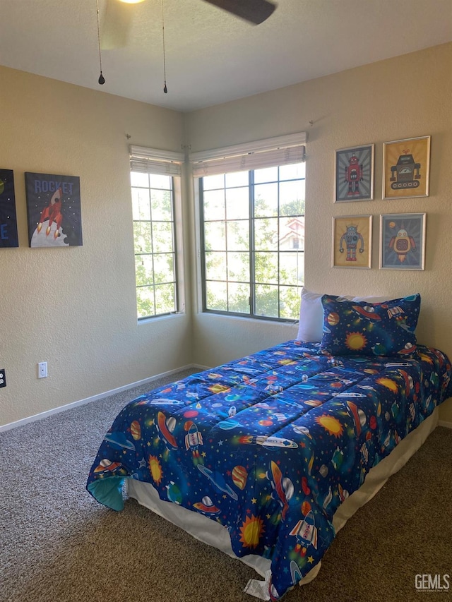 bedroom featuring carpet, ceiling fan, and multiple windows