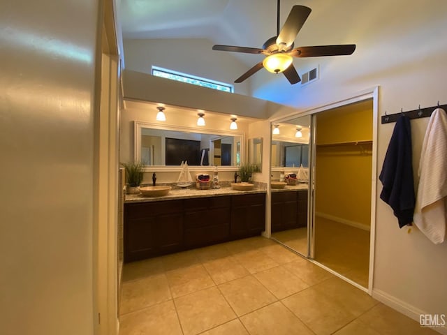 bathroom with ceiling fan, tile patterned flooring, vanity, and vaulted ceiling