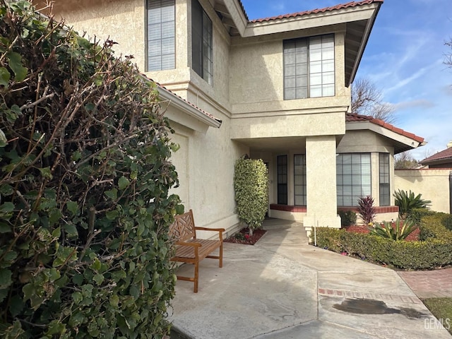 view of exterior entry featuring a patio area