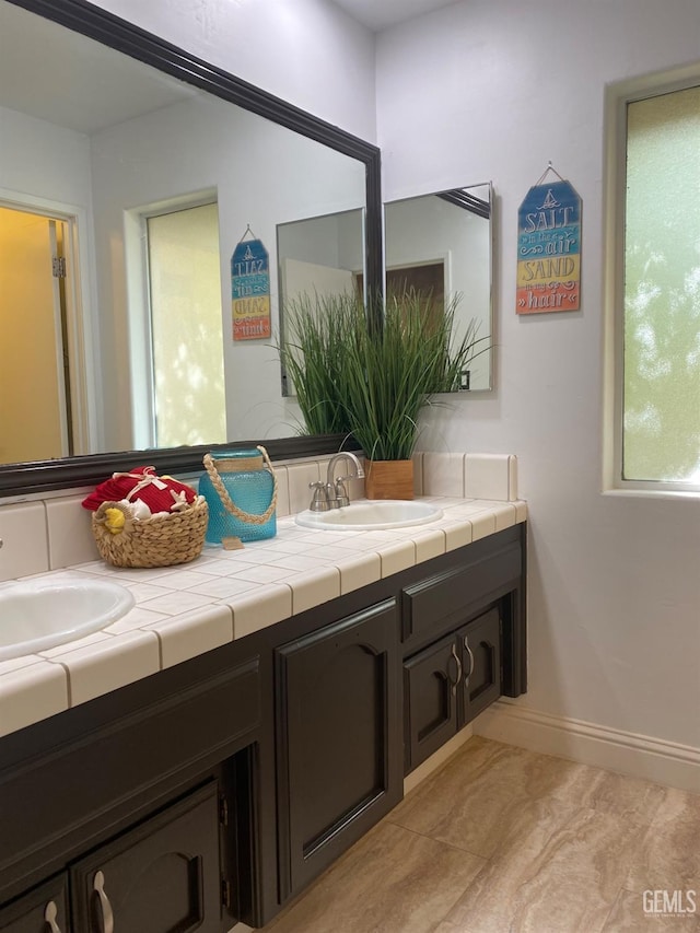 bathroom featuring tile patterned flooring and vanity