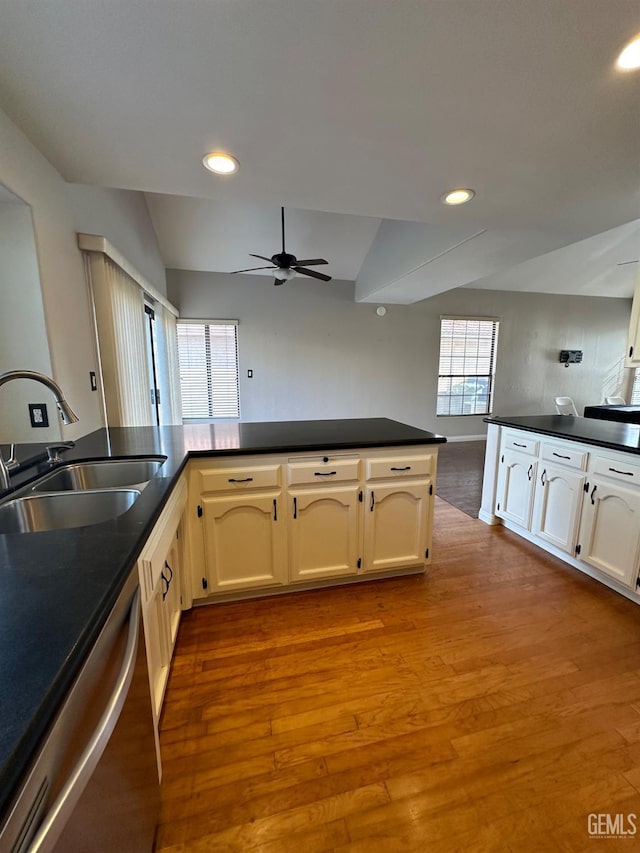 kitchen featuring stainless steel dishwasher, ceiling fan, light wood-type flooring, and sink