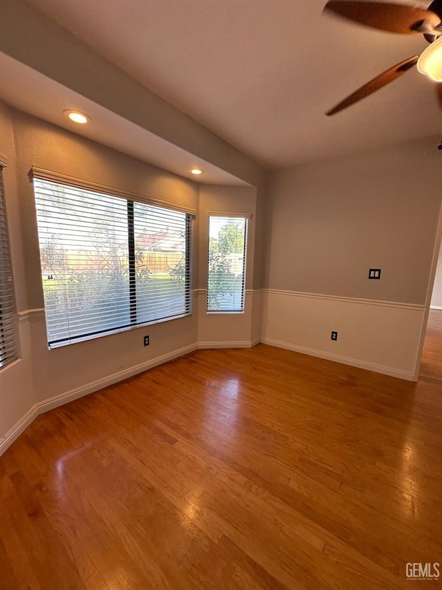 unfurnished room with ceiling fan and hardwood / wood-style floors