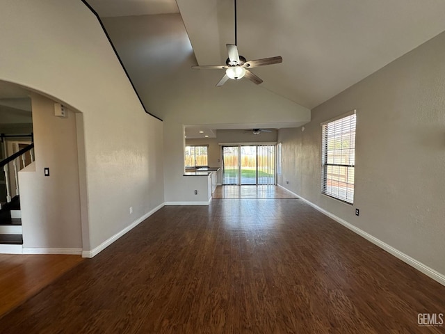 unfurnished living room with ceiling fan, hardwood / wood-style floors, and high vaulted ceiling