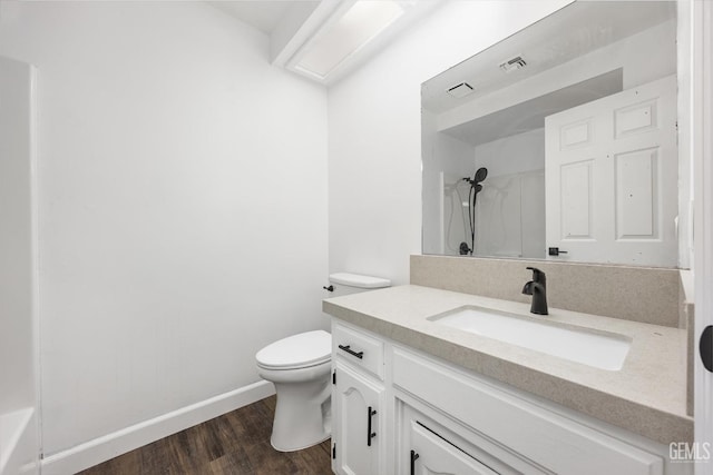 bathroom with wood finished floors, baseboards, visible vents, walk in shower, and toilet