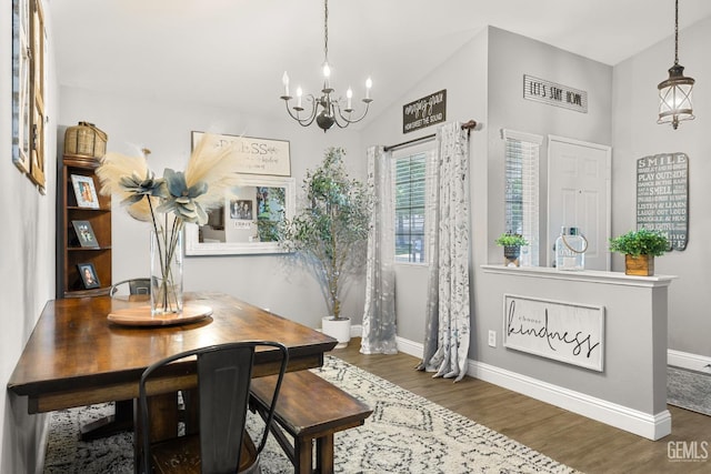 5000 Rogue Water Ct, Bakersfield, CA 93313 - dining area with a chandelier, wood finished floors, and vaulted ceiling