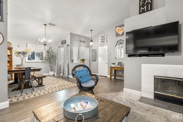 5000 Rogue Water Ct, Bakersfield, CA 93313 - living area with high vaulted ceiling, wood finished floors, a chandelier, and a fireplace