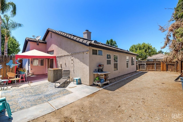 5000 Rogue Water Ct, Bakersfield, CA 93313 - rear view of house featuring a chimney, a gazebo, a patio area, a fenced backyard, and stucco siding