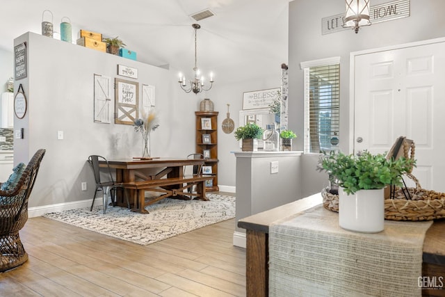 5000 Rogue Water Ct, Bakersfield, CA 93313 - dining space with a chandelier, light wood-style flooring, and vaulted ceiling