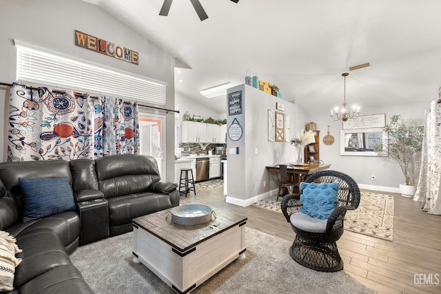 5000 Rogue Water Ct, Bakersfield, CA 93313 - living room with lofted ceiling, a ceiling fan, wood finished floors, and a chandelier