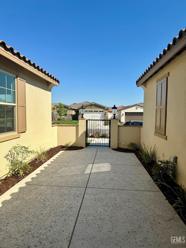 view of patio with a gate and fence