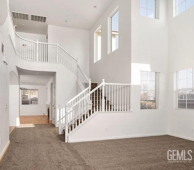 5400 Saddleback Ridge Ct, Bakersfield, CA 93313 - stairway featuring a high ceiling, carpet flooring, and plenty of natural light