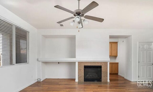 5400 Saddleback Ridge Ct, Bakersfield, CA 93313 - unfurnished living room featuring a ceiling fan, wood finished floors, and a fireplace with flush hearth