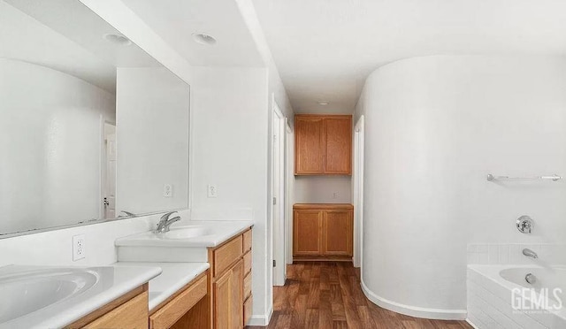 5400 Saddleback Ridge Ct, Bakersfield, CA 93313 - bathroom with vanity, a tub to relax in, and wood finished floors