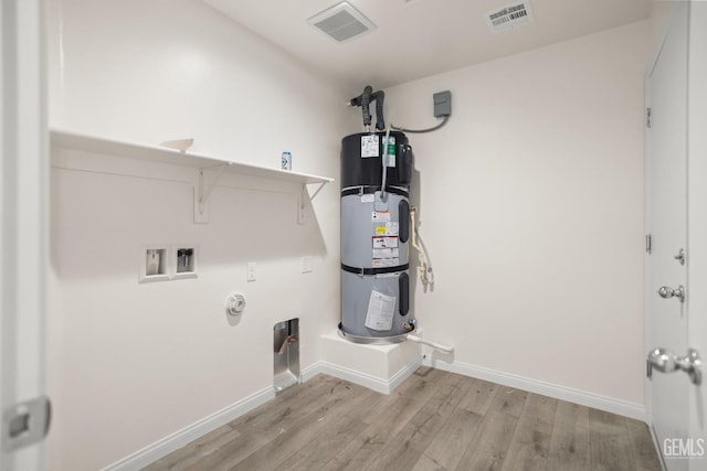 618 Poinsettia St, Bakersfield, CA 93307 - laundry area featuring washer hookup, wood finished floors, hookup for a gas dryer, and heat pump water heater