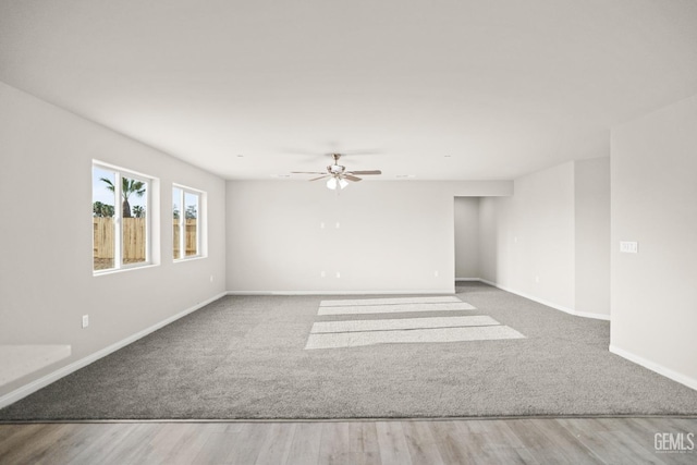 618 Poinsettia St, Bakersfield, CA 93307 - unfurnished room with carpet floors, a ceiling fan, and wood finished floors