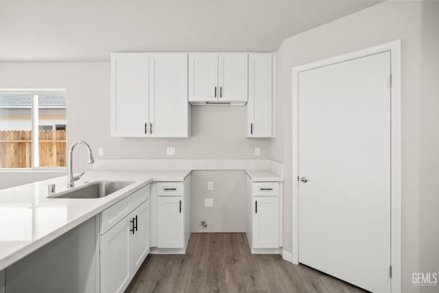 618 Poinsettia St, Bakersfield, CA 93307 - kitchen featuring wood finished floors, white cabinetry, and light countertops