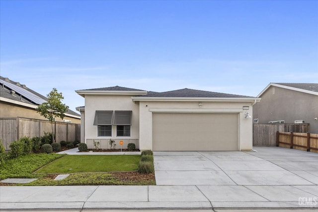 view of front of house featuring stucco siding, fence, a garage, a front yard, and concrete driveway