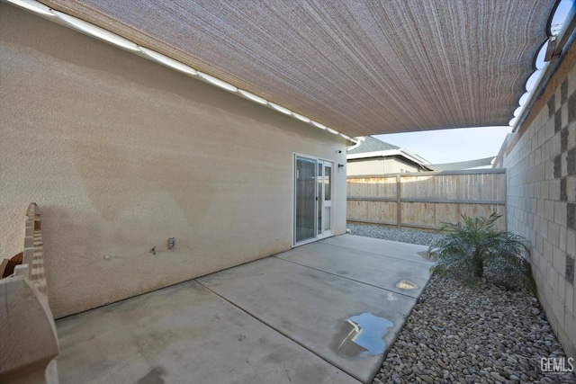 view of patio featuring fence