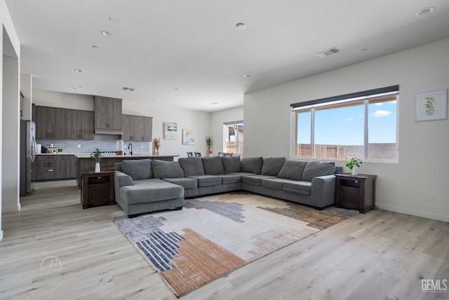 1215 Brookline Ln, Bakersfield, CA 93314 - living area featuring light wood-style floors, recessed lighting, and baseboards
