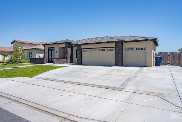 1215 Brookline Ln, Bakersfield, CA 93314 - prairie-style home featuring an attached garage, concrete driveway, stone siding, stucco siding, and a tiled roof